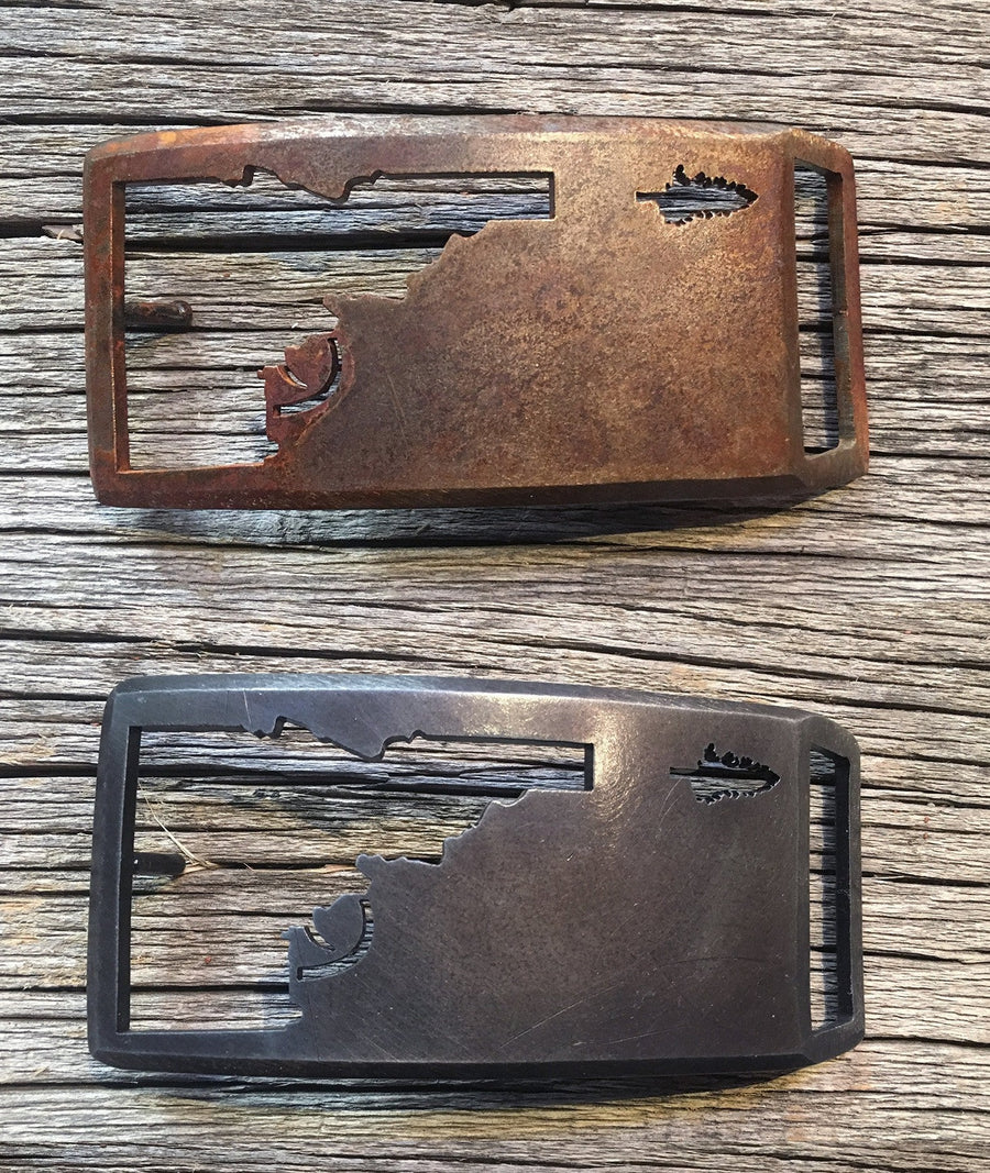 Idaho Tree-Gun Steel belt buckle, Idaho shooting a pine tree, Rust finish, Gunmetal finish, and Raw Steel finish
